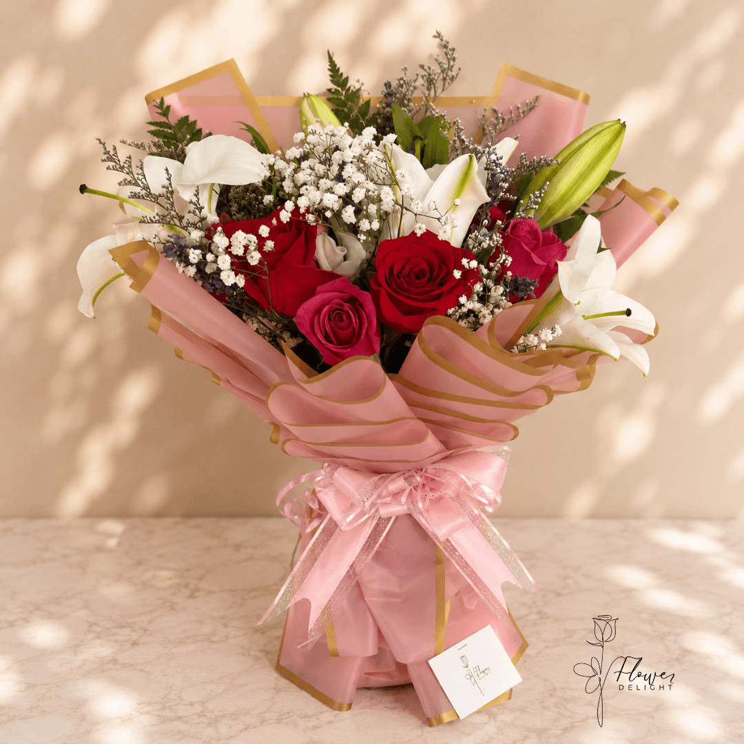 12 Red Roses and White Lilies with Pink Wrapping by Flower Delight