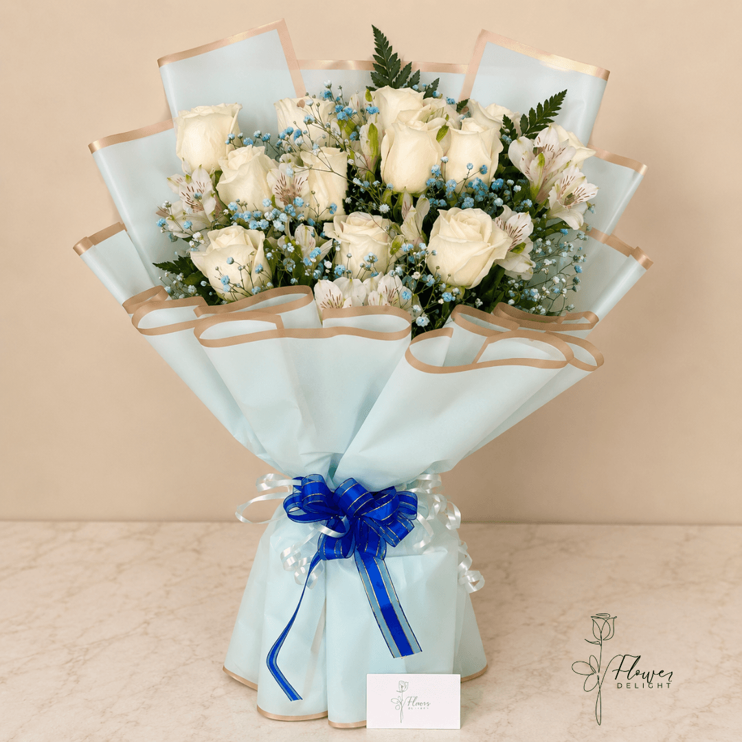 12 White Roses with Blue Wrapping by Flower Delight