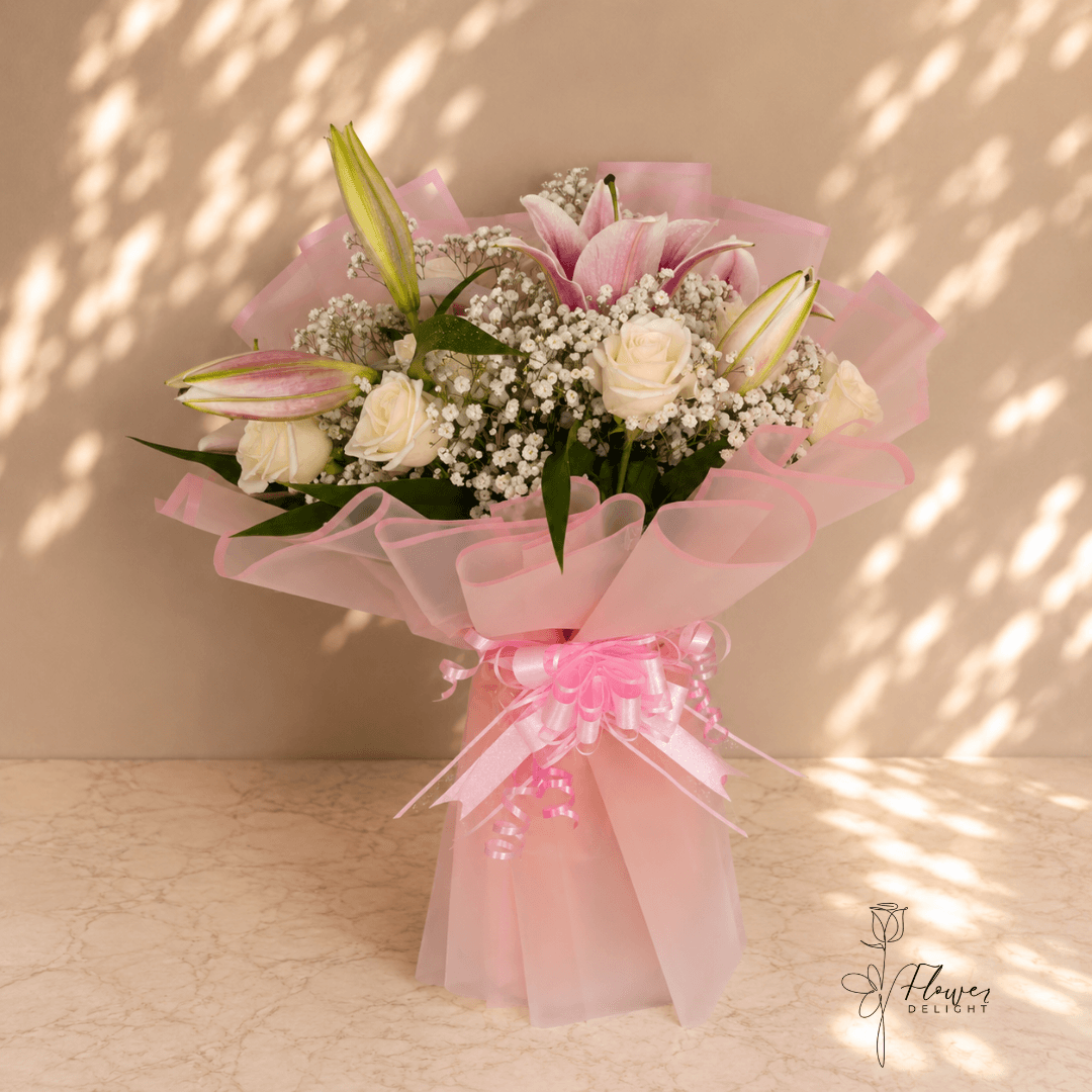 12 White Roses and Pink Lilies with Clear Pink Wrapping by Flower Delight