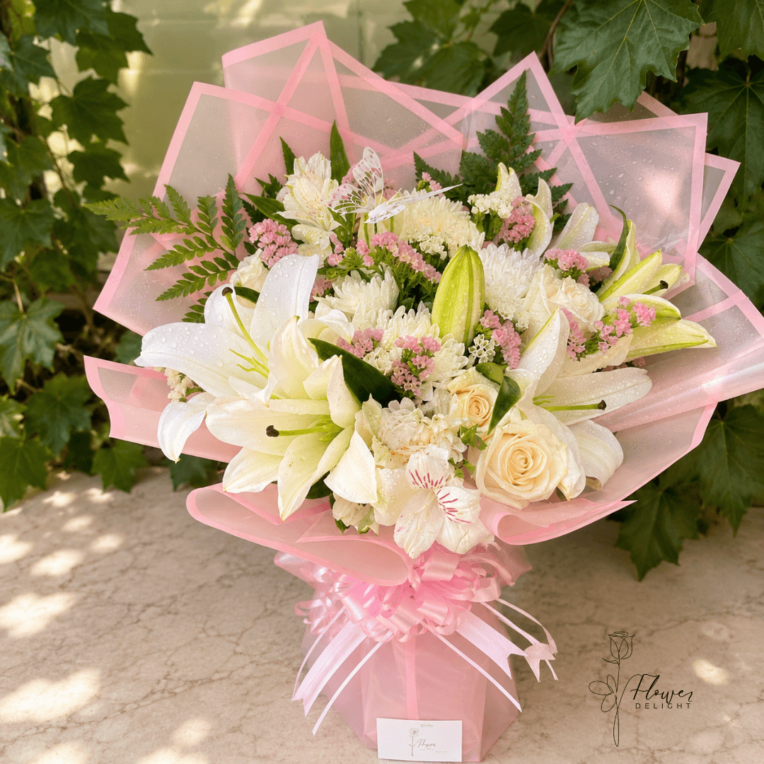12 White Roses and White Lilies with Pink Wrapping by Flower Delight