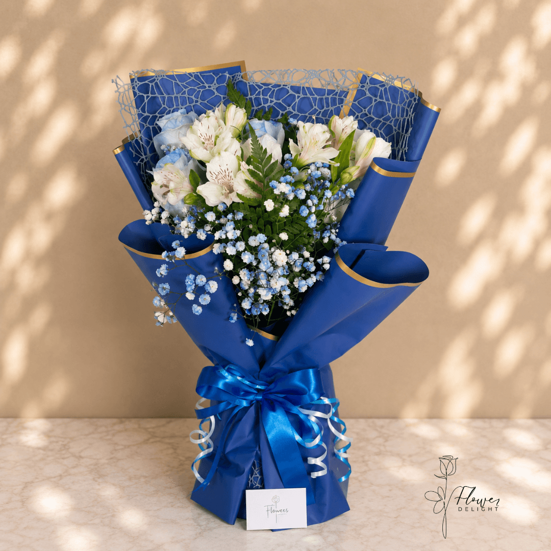6 White Roses with Dark Blue Wrapping by Flower Delight